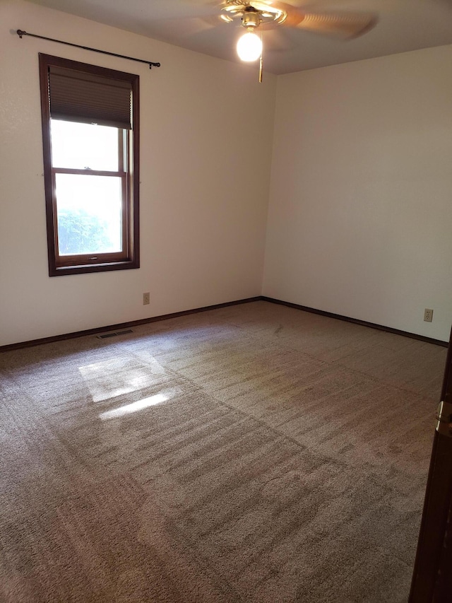 spare room featuring carpet floors and ceiling fan