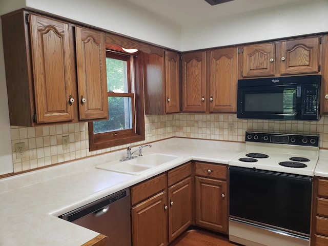 kitchen featuring white range with electric cooktop, decorative backsplash, stainless steel dishwasher, and sink