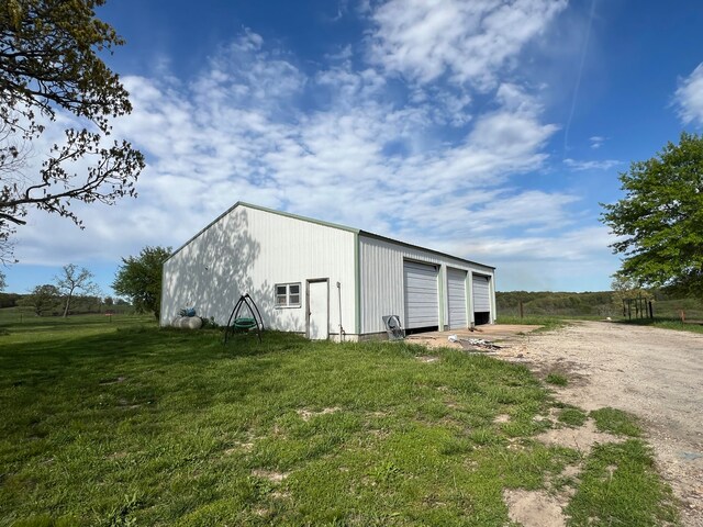 view of outbuilding with a garage and a yard