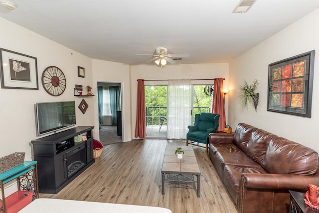 813 Holiday Rdg Unit 6, Branson, MO 65616 - living room with light wood finished floors, a ceiling fan, and visible vents