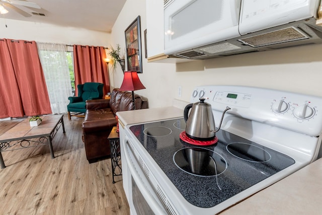 813 Holiday Rdg Unit 6, Branson, MO 65616 - kitchen with ceiling fan, visible vents, light wood-style floors, and white appliances