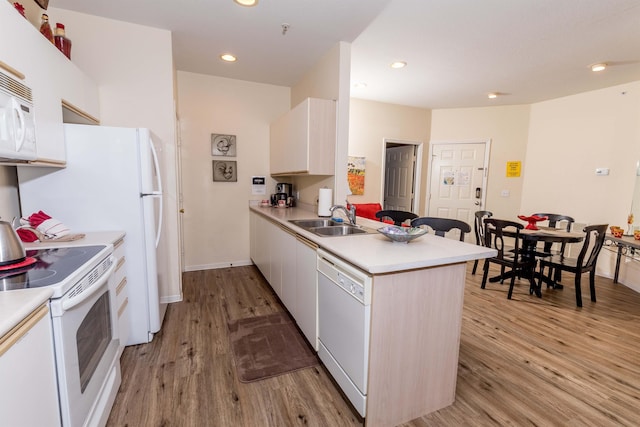 813 Holiday Rdg Unit 6, Branson, MO 65616 - kitchen featuring light wood finished floors, a sink, white appliances, and light countertops