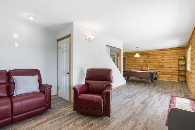 living room with billiards, hardwood / wood-style flooring, and wooden walls