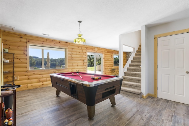 rec room with log walls, hardwood / wood-style floors, a textured ceiling, and billiards