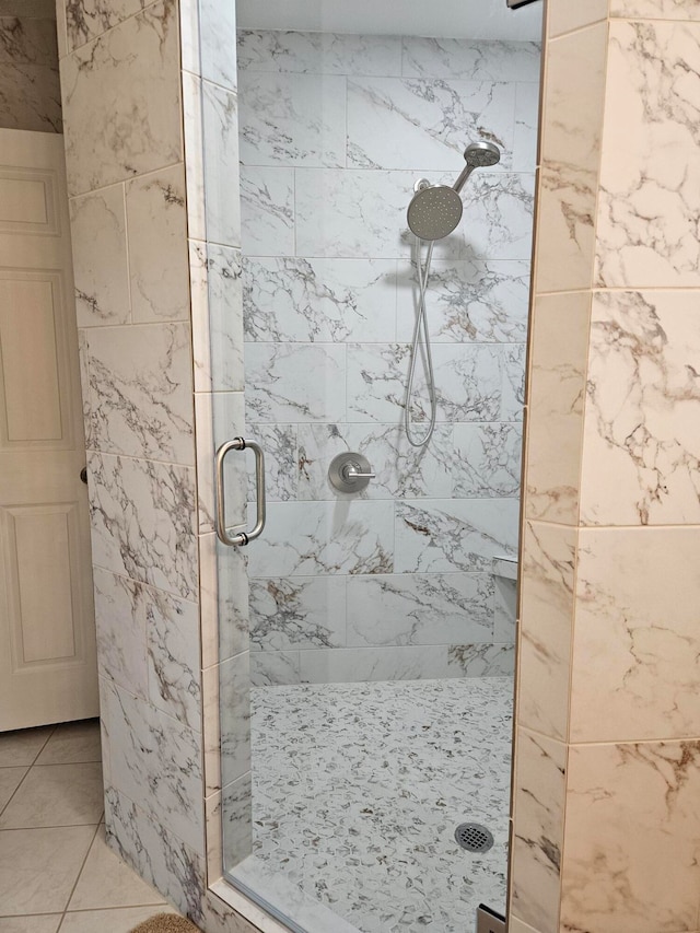 bathroom featuring tile patterned flooring and an enclosed shower