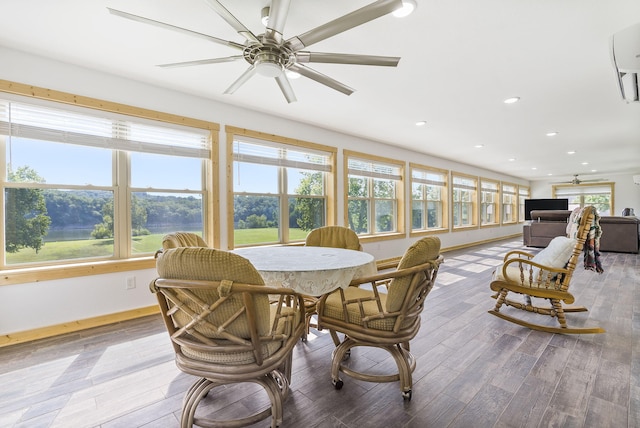 sunroom featuring ceiling fan and plenty of natural light