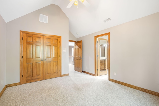 unfurnished bedroom featuring lofted ceiling, baseboards, light carpet, and visible vents