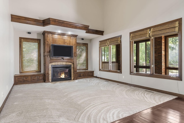 unfurnished living room with baseboards and a fireplace