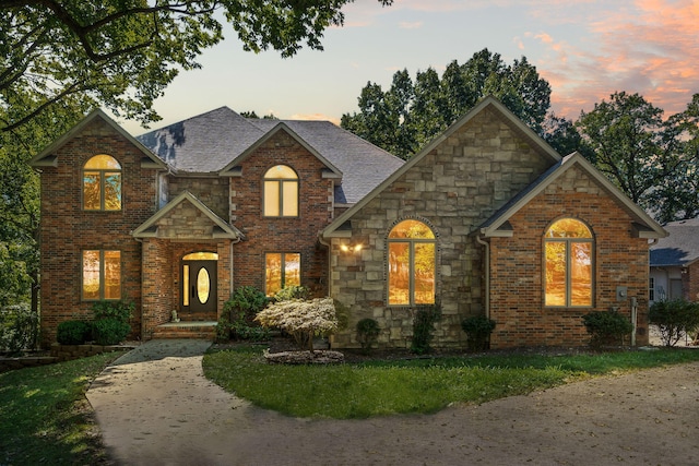 view of front of home with brick siding and stone siding