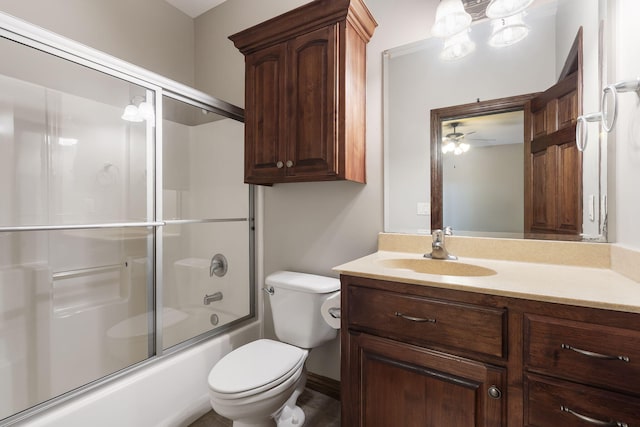 full bathroom featuring ceiling fan, vanity, toilet, and enclosed tub / shower combo