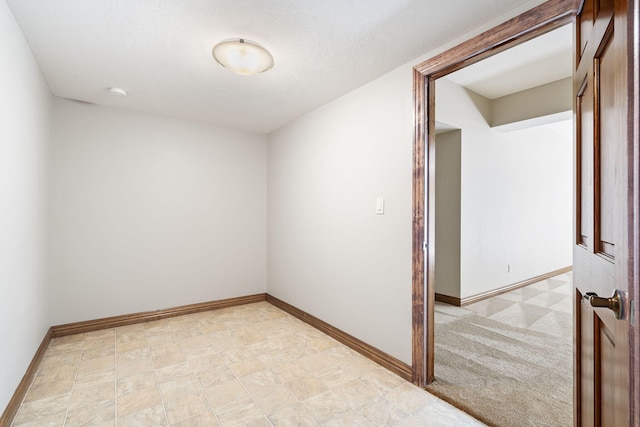 carpeted spare room featuring a textured ceiling