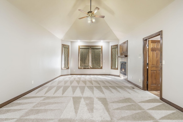 unfurnished living room with ceiling fan, high vaulted ceiling, and light carpet