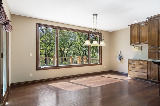 unfurnished dining area with visible vents, baseboards, and dark wood-style flooring