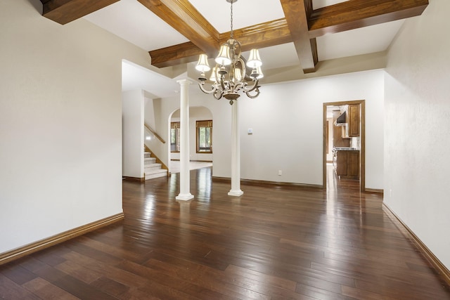 unfurnished dining area with an inviting chandelier, dark hardwood / wood-style floors, beamed ceiling, and decorative columns