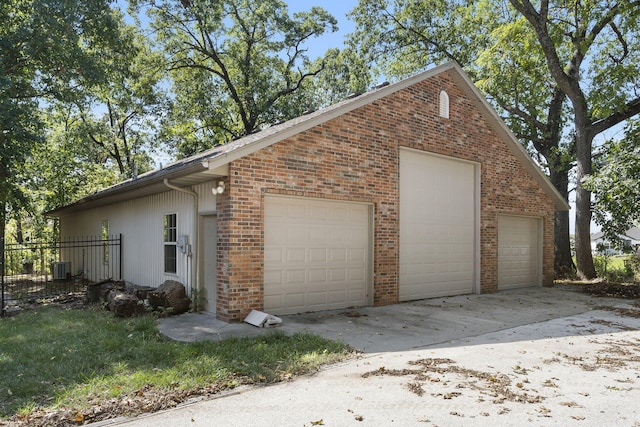 detached garage with fence and cooling unit