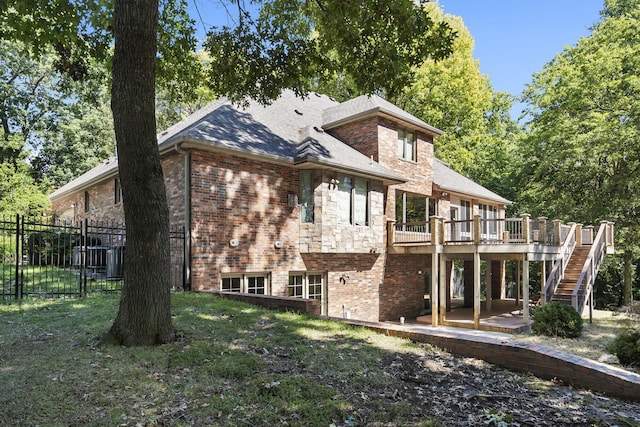 back of property featuring stairs, fence, a wooden deck, a patio area, and brick siding