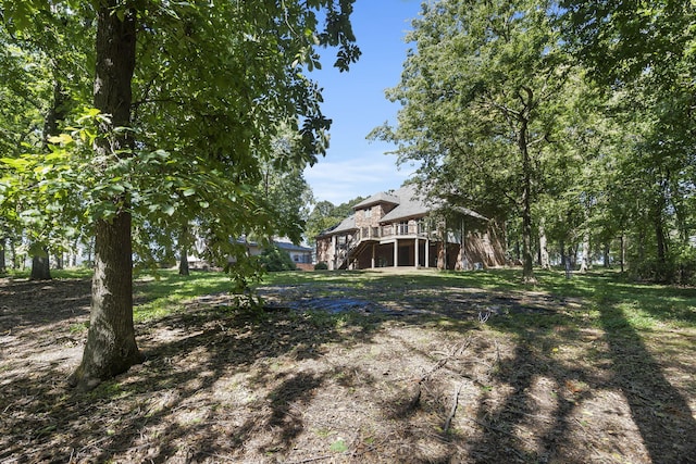 view of yard featuring stairs and a deck