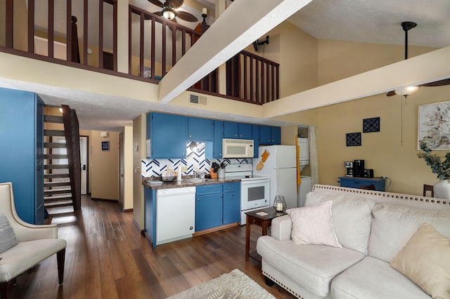 living room with ceiling fan, dark hardwood / wood-style flooring, sink, high vaulted ceiling, and a textured ceiling