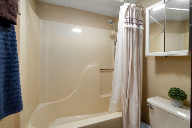 bathroom with shower / bath combination with curtain and toilet