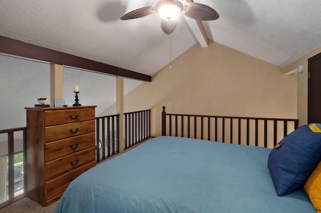 carpeted bedroom with vaulted ceiling with beams, a textured ceiling, and ceiling fan