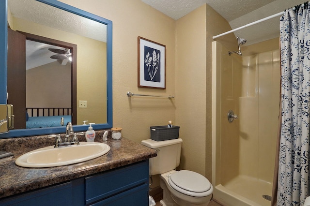 bathroom with a textured ceiling, a shower with shower curtain, vanity, and toilet