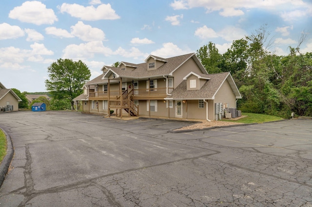 view of front of house with a garage and central air condition unit