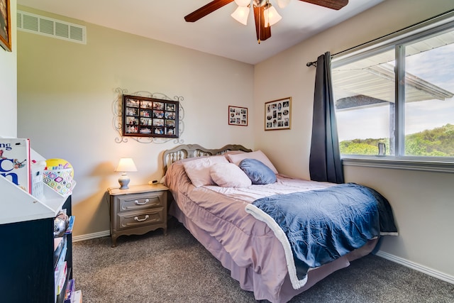 bedroom featuring ceiling fan and dark carpet