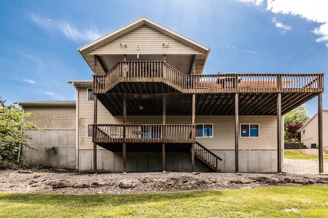 back of property featuring a yard and a wooden deck