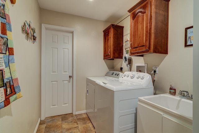 laundry area with washer and clothes dryer, sink, and cabinets