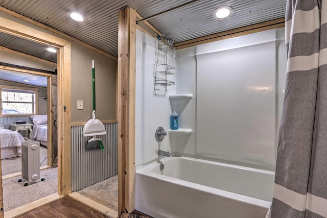 bathroom featuring hardwood / wood-style flooring and shower / bath combo