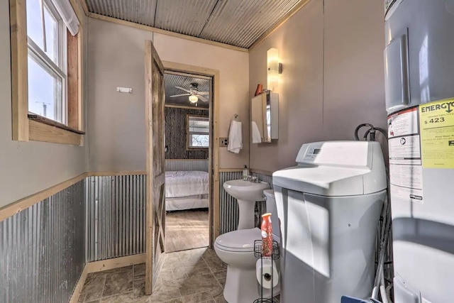 bathroom featuring sink, water heater, toilet, and ceiling fan