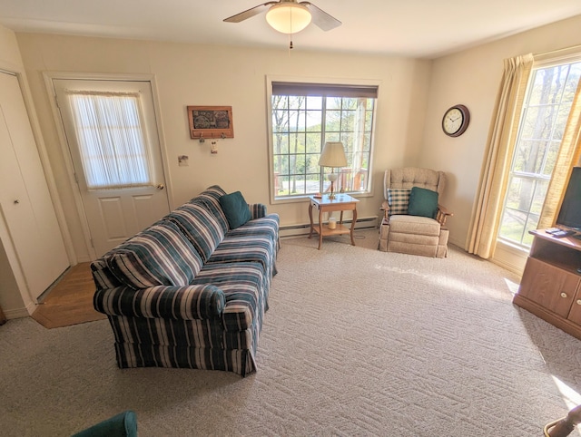 carpeted living room featuring ceiling fan and a baseboard radiator