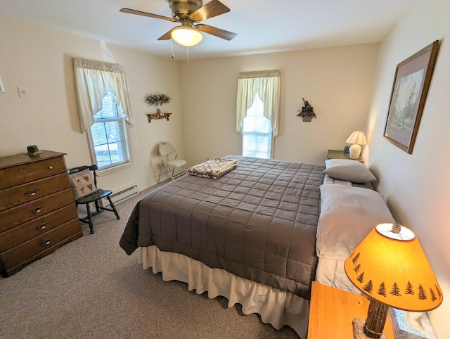 carpeted bedroom featuring multiple windows, ceiling fan, and a baseboard radiator