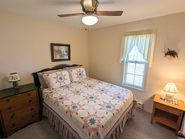 carpeted bedroom with ceiling fan and a baseboard radiator