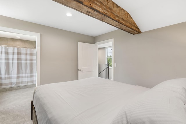 carpeted bedroom with vaulted ceiling with beams