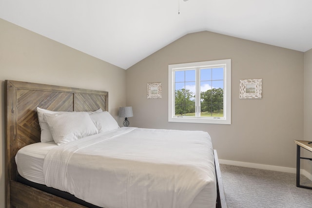 bedroom with dark carpet and lofted ceiling