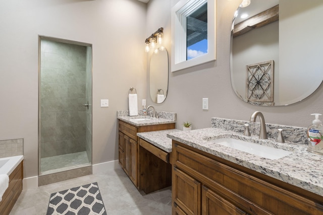 bathroom with tile patterned floors, vanity, and independent shower and bath