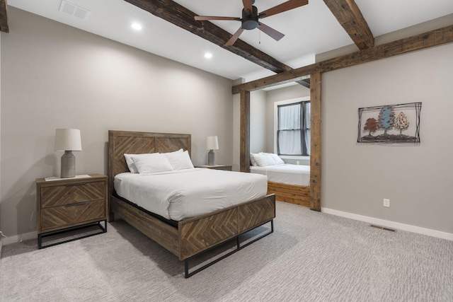 bedroom with beamed ceiling, ceiling fan, and light colored carpet