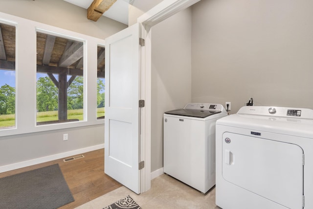 395 Tracy St, Branson, MO 65616 - laundry room featuring washing machine and clothes dryer, laundry area, light wood-style flooring, baseboards, and visible vents