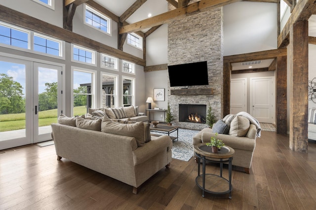 living room with beamed ceiling, a fireplace, dark hardwood / wood-style flooring, and high vaulted ceiling