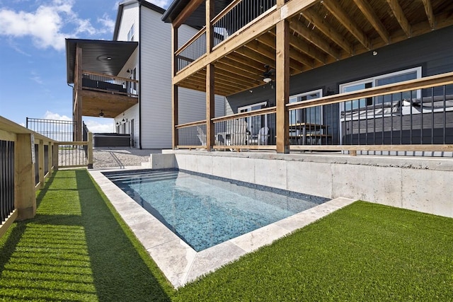 view of swimming pool featuring a lawn