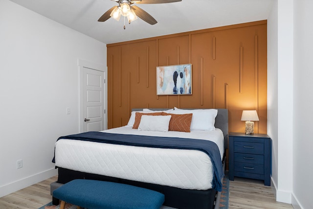 bedroom featuring light wood-type flooring, ceiling fan, and a closet