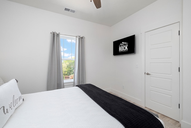 bedroom with light hardwood / wood-style flooring and ceiling fan