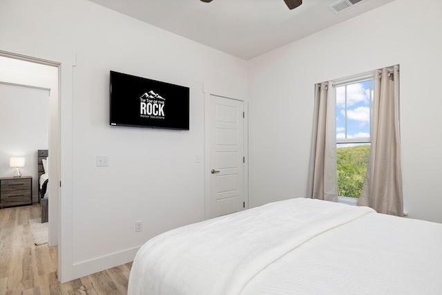 bedroom with ceiling fan and light hardwood / wood-style flooring