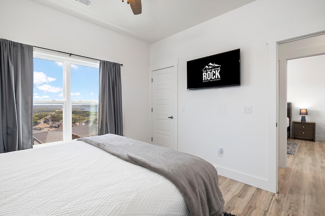 bedroom with ceiling fan and light hardwood / wood-style flooring