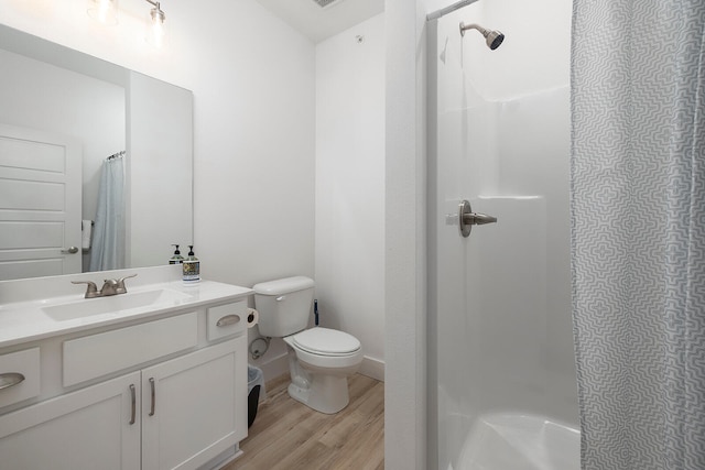 bathroom with hardwood / wood-style flooring, vanity, and toilet