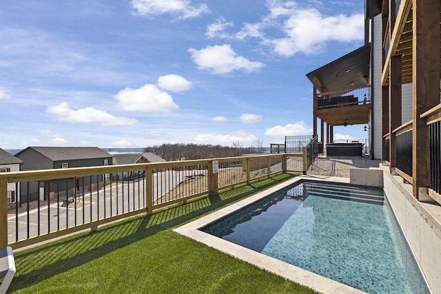 view of swimming pool featuring a yard and a patio area