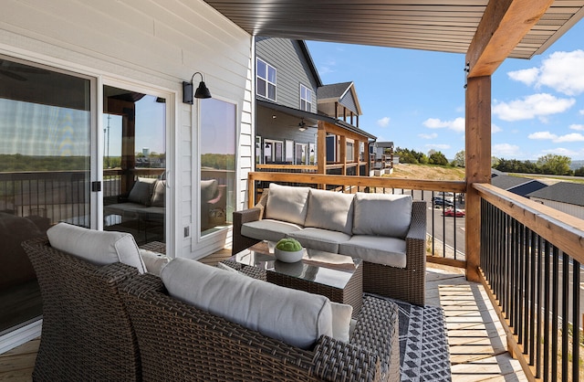 wooden balcony with an outdoor living space and a deck