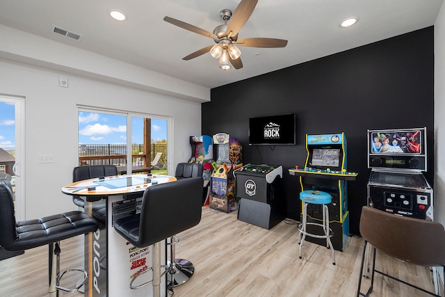 game room featuring light hardwood / wood-style floors and ceiling fan