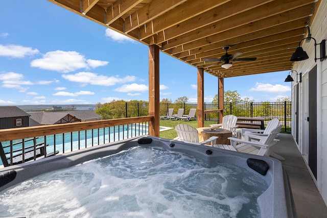 view of patio / terrace with ceiling fan and a hot tub